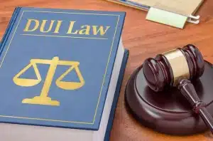 A snapshot of a gavel and a DUI law book, symbolizing the critical role of the DMV in DUI cases.